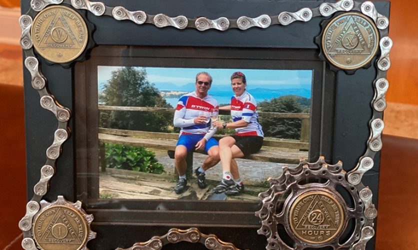 Framed photograph of William and Chantal, Caron alumni, in bike racing uniforms.