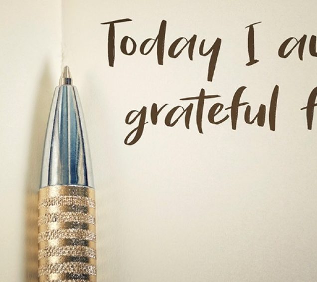 Ball point pen against paper with the words "Today I am grateful for" written down.