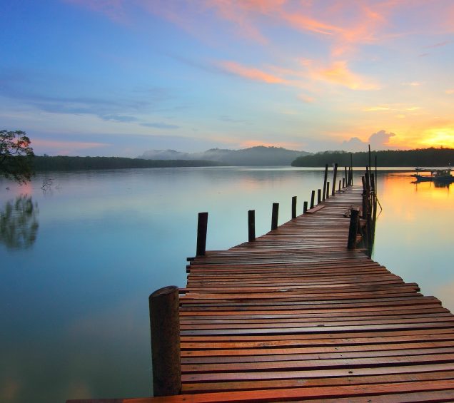 Dock overlooking a beautiful multicolored sunset.