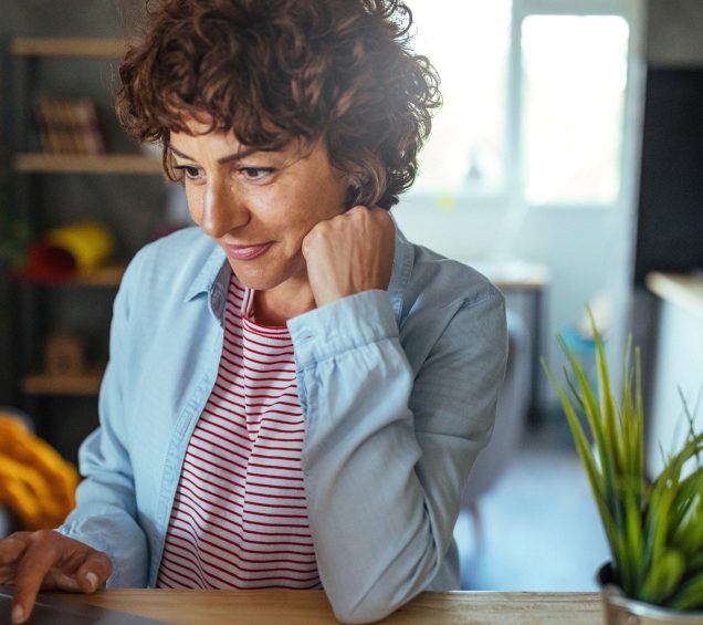 Woman browsing the internet at home.