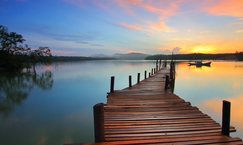 Dock overlooking a beautiful multicolored sunset.