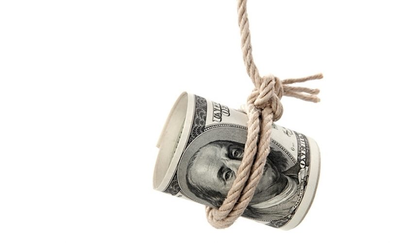 A rolled one hundred dollar bill with a rope tied around it, dangling from above.