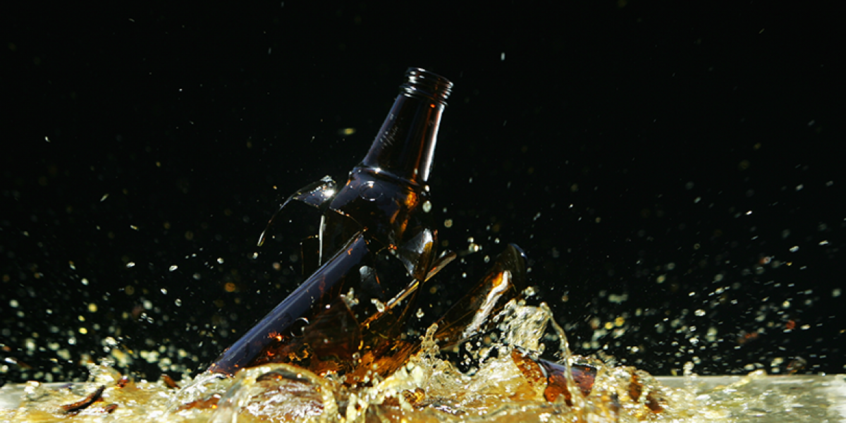 Broken beer bottle shattering on the floor.