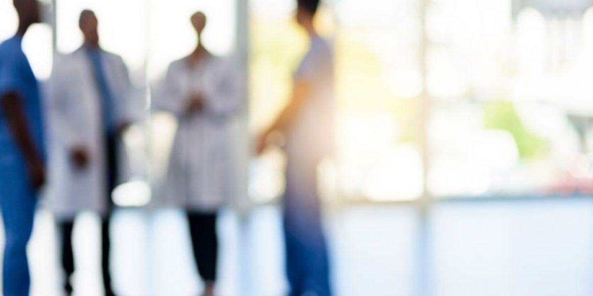 Out of focus image of a group of doctors talking.