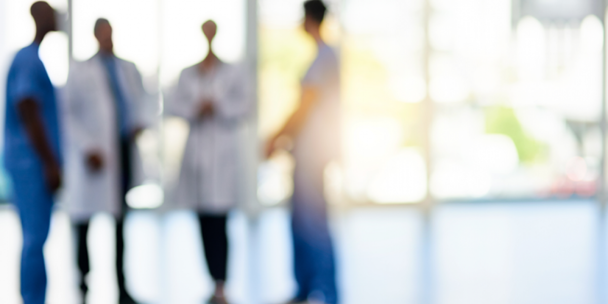 Out of focus image of a group of doctors talking.