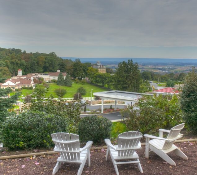 View of the Caron Pennsylvania campus with green trees and areas for sitting.