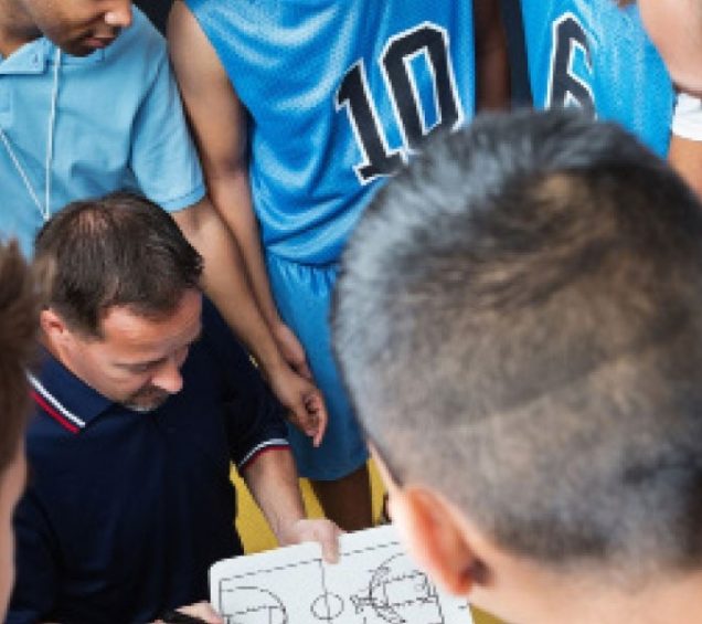 basketball players in huddle