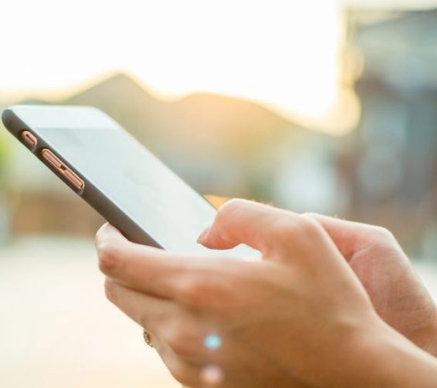 Hands holding cellphone