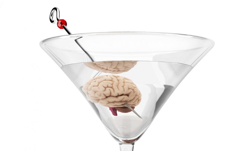 Close up of a martini with a brain replacing the olive.